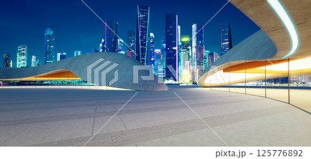 3d rendering Modern parking lot structure overlooking illuminated city skyline at night 3d rendering Modern parking lot structure overlooking illuminated city skyline at night 125776892