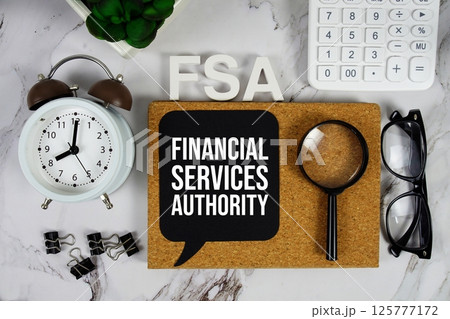 FSA - Financial Services Authority acronym with calculator, alarm clock and magnifying glass, Business and Financial concept background FSA - Financial Services Authority acronym with calculator, alarm clock and magnifying glass, Business and Financial concept background 125777172