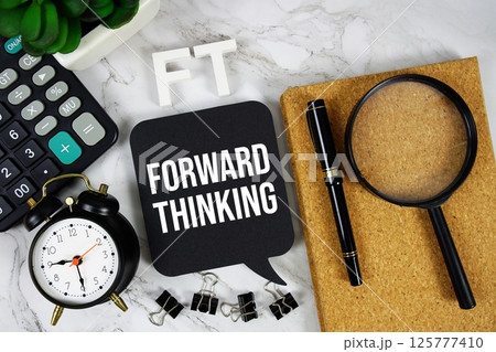 FT - Forward Thinking acronym with calculator, alarm clock and magnifying glass, business concept background 125777410