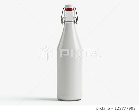 Clear glass bottle filled with fresh milk standing on a plain background in bright lighting Clear glass bottle filled with fresh milk standing on a plain background in bright lighting 125777908