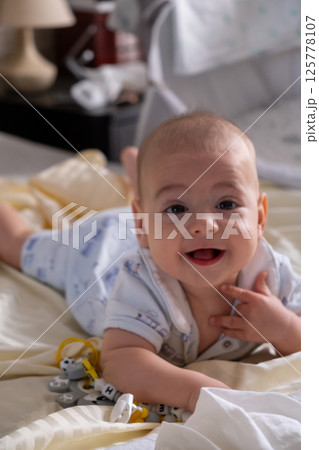 Happy Baby Playing with Toys on a Blanket Happy Baby Playing with Toys on a Blanket 125778107