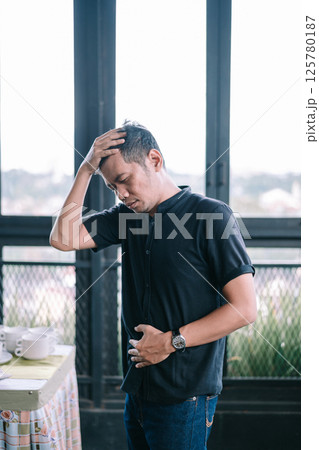 stressed man with head in hands on head stressed man with head in hands on head 125780187