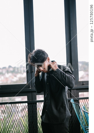 asian businessman thinking and looking through binoculars asian businessman thinking and looking through binoculars 125780196