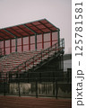 A large stadium featuring bright red seats and a striking red roof 125781581