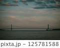 A bridge over water with a cloudy sky in the background 125781588