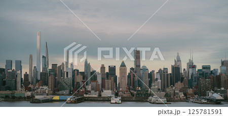 A blurry city skyline picture with a river in the foreground 125781591