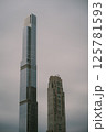 Two tall buildings stand next to each other on a cloudy day 125781593