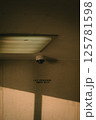 A security camera is strategically mounted on the ceiling of the building 125781598