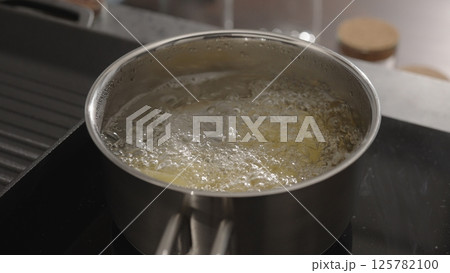 fettuccine boiling in saucepan with back light 125782100