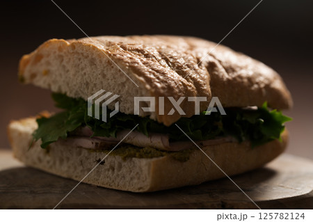 Ciabatta sandwich with ham and pesto closeup 125782124