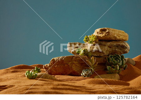 Rough rocks with many angles and depressions everywhere, stacked on top of each other to form rocky mountains in the desert. Succulent plants of different sizes grow from the crevices of the rocks.  125782164
