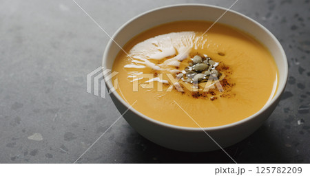 pumpkin cream soup in white bowl on terrazzo countertop pumpkin cream soup in white bowl on terrazzo countertop 125782209