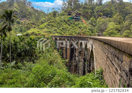 Historic Nine Arches Bridge in lush jungle near Ella, Sri Lanka, no people visible 125782834