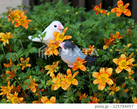 オレンジ色の花と2羽の小鳥の置物 125784057