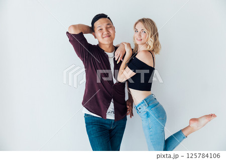 Man And Woman Standing Together Side By White Wall Man And Woman Standing Together Side By White Wall 125784106