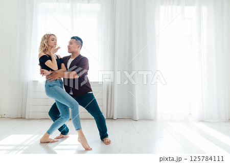 Man and woman dancing together to music 125784111