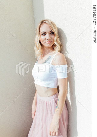Portrait of a blonde woman in a summer light dress on a white background Portrait of a blonde woman in a summer light dress on a white background 125784191