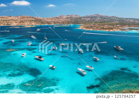 Aerial view of luxury yachts and boats on blue sea, island Aerial view of luxury yachts and boats on blue sea, island 125784257