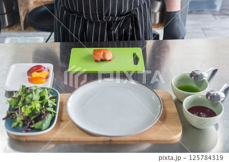 The chef slices the roast duck. The chef slices the roast duck. 125784319
