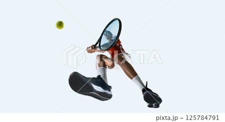 Tennis player swings from side view with visible shoe sole and force against white studio background. Tennis player swings from side view with visible shoe sole and force against white studio background. 125784791
