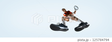 Bottom view of man, tennis player in motion, tosses ball high and prepares swing with racket from low view against white studio background. 125784794