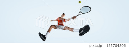 Bottom view of focused man, tennis player stretches legs in wide split, hitting ball mid-air with fierce focus against white studio background 125784806