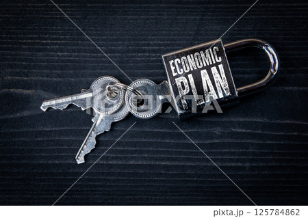 Economic Plan Concept. Padlock on black wooden texture background 125784862