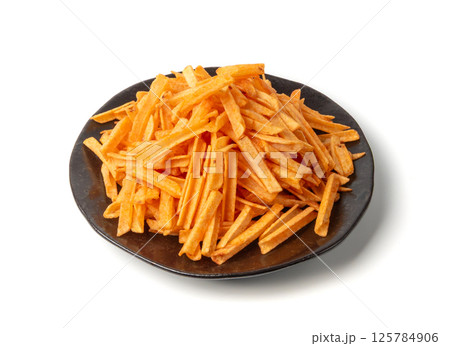 Fried chips sticks isolated, finger potato chips, golden shoestring fries pile, French fries Fried chips sticks isolated, finger potato chips, golden shoestring fries pile, French fries 125784906