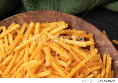 Fried chips sticks, finger potato chips, golden shoestring fries pile, French fries 125784922
