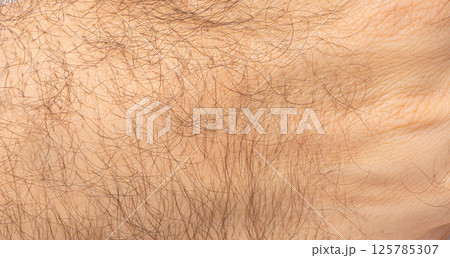 Macro texture of hairy human skin, close view of male arm, body hair, natural surface pattern 125785307