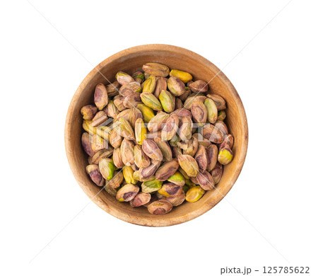 Fried salt pistachio nuts isolated. Baked pistachios pile, roasted green pistache fruits on white Fried salt pistachio nuts isolated. Baked pistachios pile, roasted green pistache fruits on white 125785622