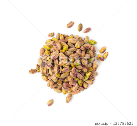 Fried salt pistachio nuts isolated. Baked pistachios pile, roasted green pistache fruits on white Fried salt pistachio nuts isolated. Baked pistachios pile, roasted green pistache fruits on white 125785623