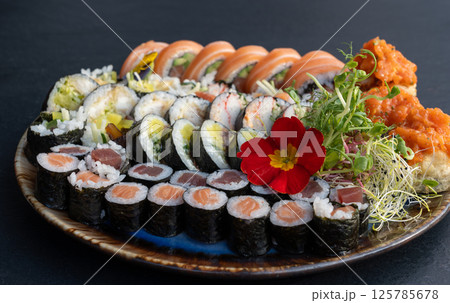 Sushi platter with assorted rolls salmon, tuna, cucumber, avocado, seaweed, rice, tempura Sushi platter with assorted rolls salmon, tuna, cucumber, avocado, seaweed, rice, tempura 125785678