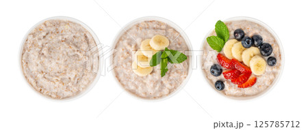Cooked spelt in bowl isolated. Oatmeal milk porridge with fruits and berries Cooked spelt in bowl isolated. Oatmeal milk porridge with fruits and berries 125785712