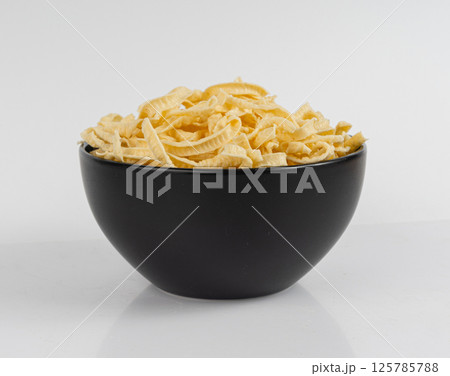 Passatelli spatzle pasta isolated, raw spaetzle noodles, dry homemade german macaroni Passatelli spatzle pasta isolated, raw spaetzle noodles, dry homemade german macaroni 125785788