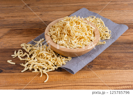 Passatelli spatzle pasta in bowl, raw spaetzle noodles, dry homemade german macaroni Passatelli spatzle pasta in bowl, raw spaetzle noodles, dry homemade german macaroni 125785796