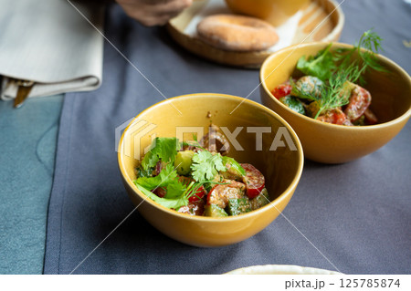 Georgian salad of fresh vegetables with nut dressing. Traditional glekhurad salat Georgian salad of fresh vegetables with nut dressing. Traditional glekhurad salat 125785874
