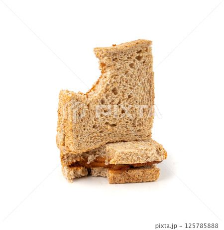Bitten dried pate sandwich isolated, low-quality food leftovers, bad quality toast bread lunch 125785888