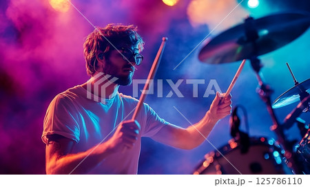Drummer Immersed in Performance Amidst Vibrant Concert Lights Drummer Immersed in Performance Amidst Vibrant Concert Lights 125786110