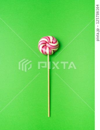 Color lollipop, spiral candy on stick, colorful striped lollypop, round fruit caramel, circle lollipop 125786164