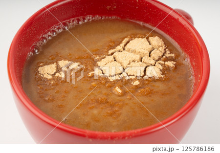 Maca powder drink isolated, dry Peruvian ginseng beverage, powder in water, ground ayak willku tea 125786186