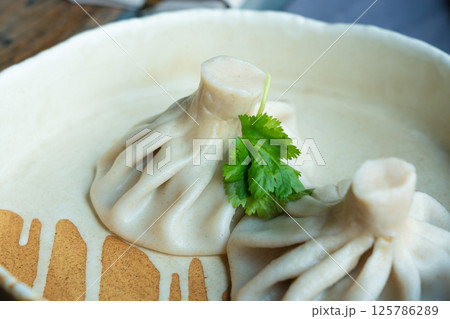Georgian khinkali or chinkali with minced meat. Traditional spicy Georgian steamed dumplings Georgian khinkali or chinkali with minced meat. Traditional spicy Georgian steamed dumplings 125786289