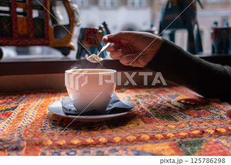 Masala chai an Indian restaurant, spiced milk tea, traditional cardamom hot drink with spices Masala chai an Indian restaurant, spiced milk tea, traditional cardamom hot drink with spices 125786298