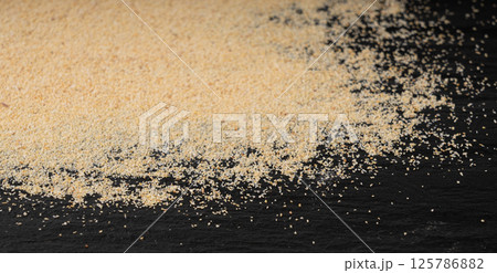 Garlic powder pile texture, dried granulated chopped crushed garlic pattern, small pieces 125786882