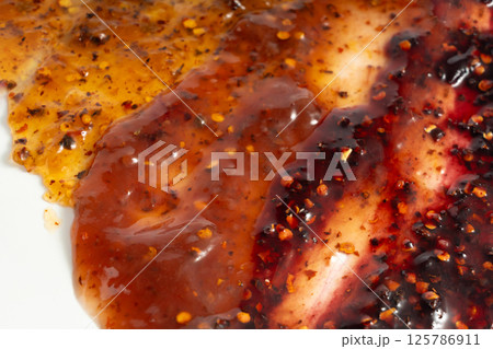 Color jam with chili, chilli pepper marmalade smear mix, spicy fruit jelly fruity confiture smudge 125786911