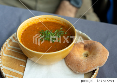 Spicy kharcho or harcho soup, traditional Georgian chowder. Creamy kharcho broth Spicy kharcho or harcho soup, traditional Georgian chowder. Creamy kharcho broth 125787294