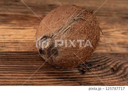 Whole coconut, one coco nut, single fresh tropical palm fruit, natural milk, oil ingredient 125787717