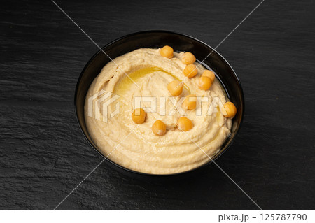 Hummus in bowl, houmous dip, chickpea humus tahini sauce, middle eastern spread Hummus in bowl, houmous dip, chickpea humus tahini sauce, middle eastern spread 125787790