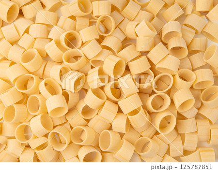 Raw Calamarata Big Pasta Isolated, Homemade Dry Macaroni, Italian Raw Round Noodle 125787851