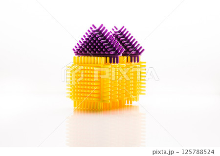 The toddler construction set consists of bright pieces that easily connect with each other. The parts of the play set are placed on a white background. The toddler construction set consists of bright pieces that easily connect with each other. The parts of the play set are placed on a white background. 125788524